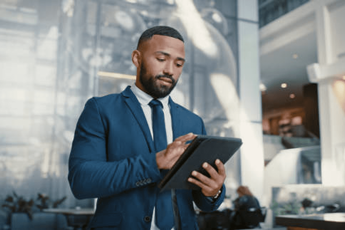 Confident businessman using a digital tablet in a modern office.
