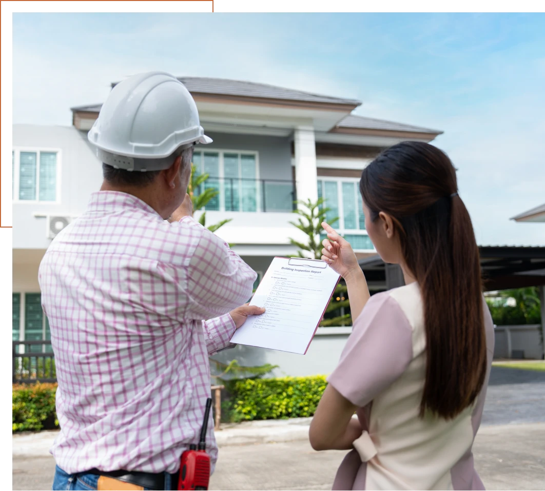 Construction worker and woman inspecting house